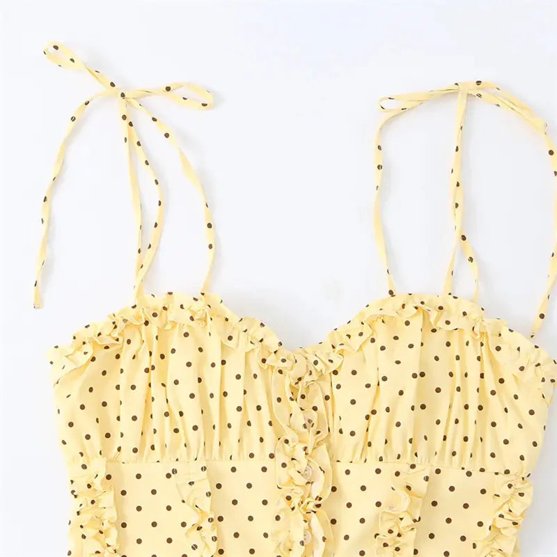 Closeup sweetheart neckline, frill ruffle edge, adjustable self fabric tie shoulder straps, brown polka dot fabric