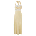 Front view of pale yellow halter neck satin maxi dress with white lace trim