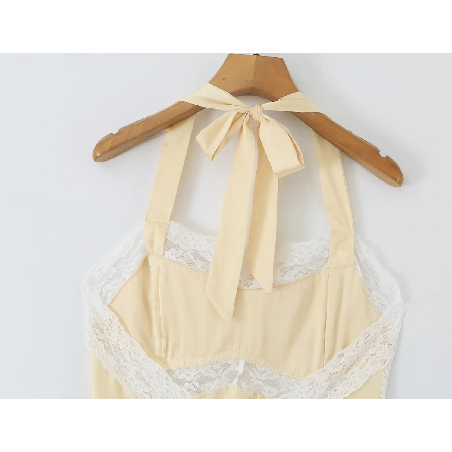 Hanger close‑up of halter straps and lace bust overlay