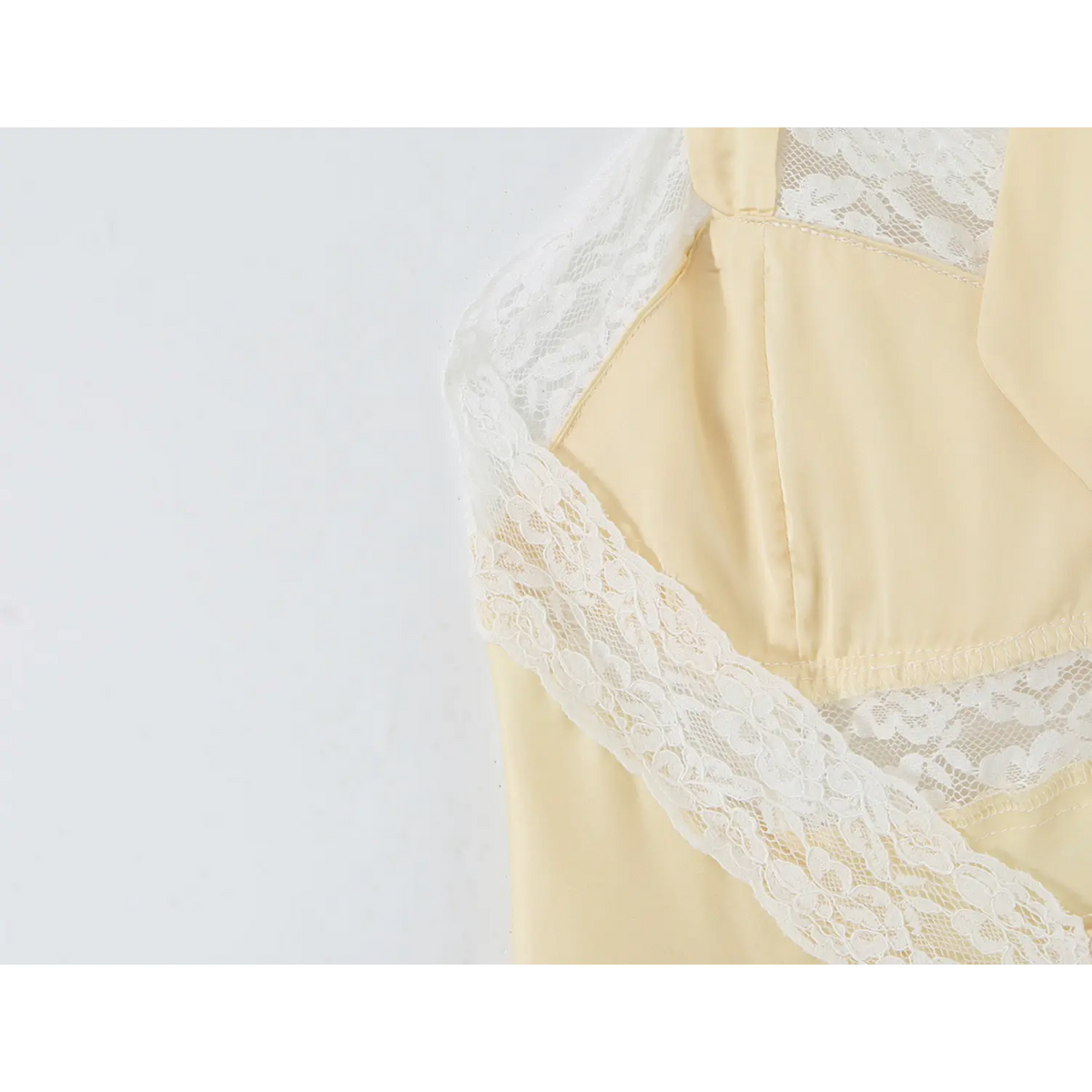 Partial close‑up of side lace trim and satin seam detail