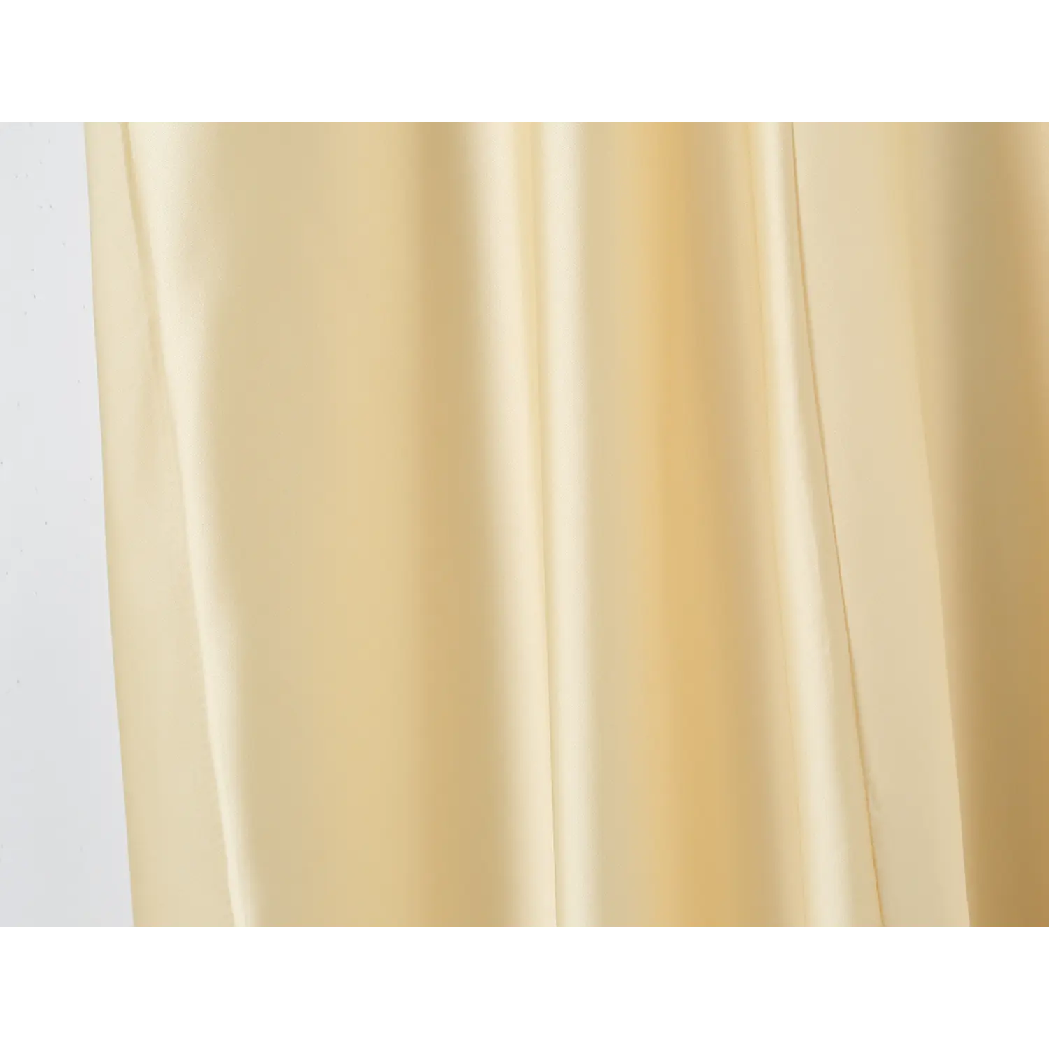 Close‑up of drape and sheen of pale yellow satin maxi skirt