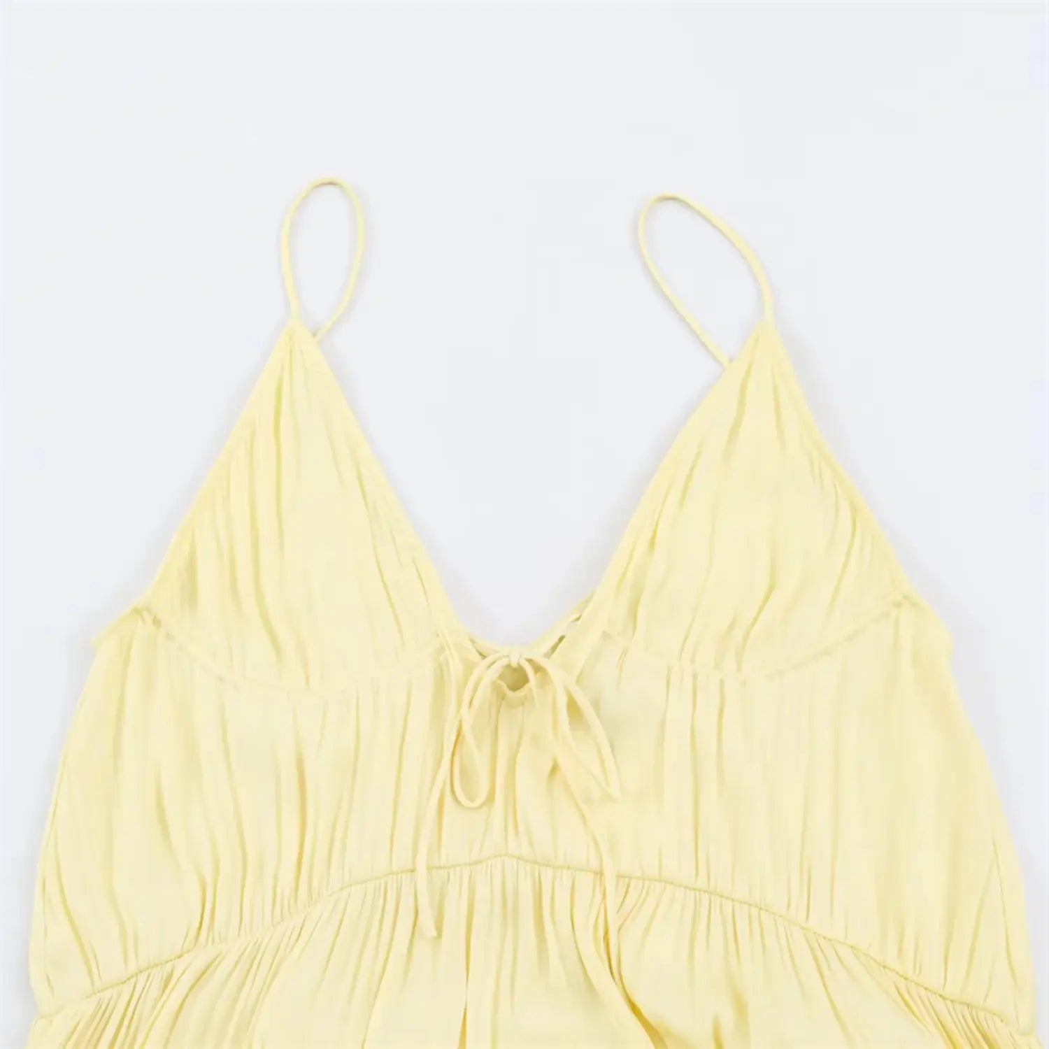 Close‑up of back v‑neck with fabric tie knot detail