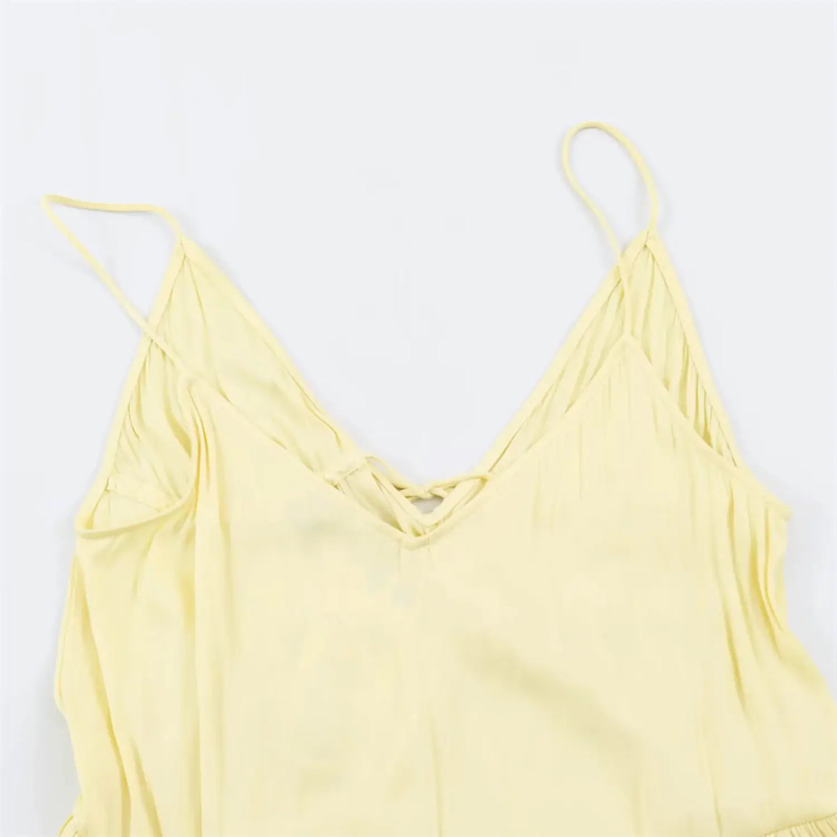 Partial front view of v‑neckline and smocked bust