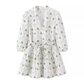 Front flat lay view white palm tree print mini dress, v-neck, 3/4 puff sleeves, self fabric tie waist, tiered ruffle hem