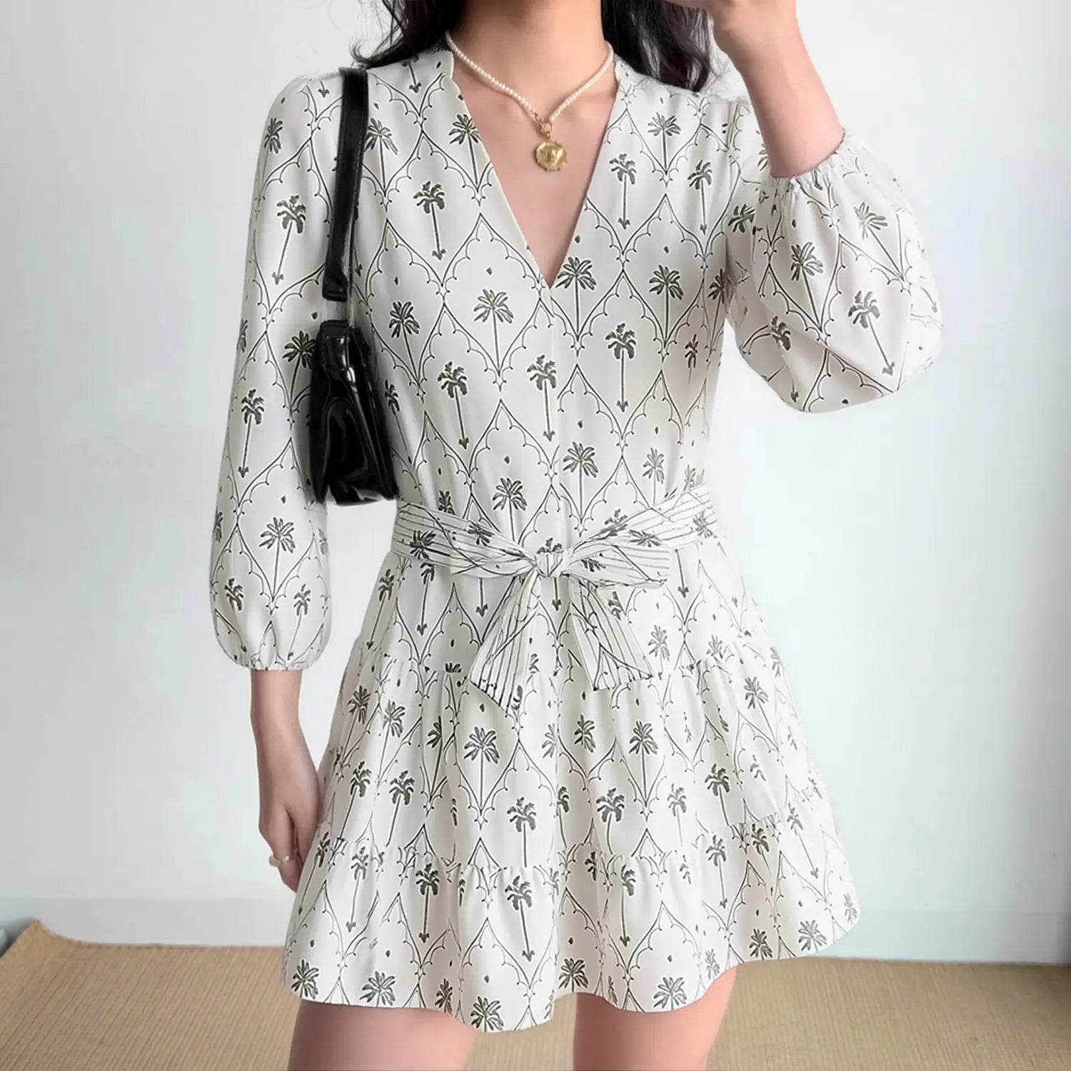 Model front view wearing palm tree print mini dress, show overall fit and silhouette