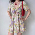 Female model wearing vintage floral print v-neck cutout mini dress, indoor lifestyle outfit photo