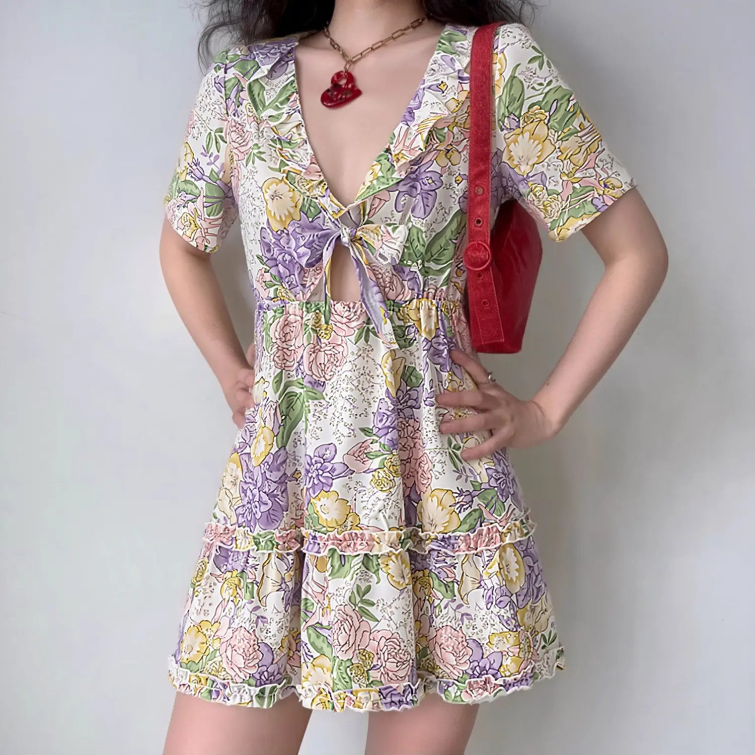 Female model wearing vintage floral print v-neck cutout mini dress, indoor lifestyle outfit photo