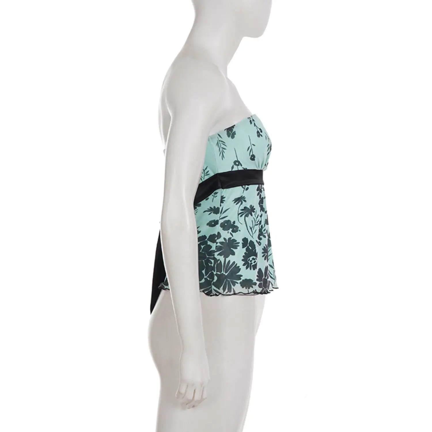 Side profile white studio mannequin shot of peplum bandeau top, mint sheer mesh with black floral pattern, thick black satin waist trim, long satin back tie hanging down, fitted waist flared mini peplum hem