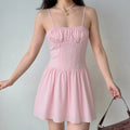 Indoor lifestyle photo of blush pink corset sundress paired with vintage brown handbag, sweet casual daily dating outfit.
