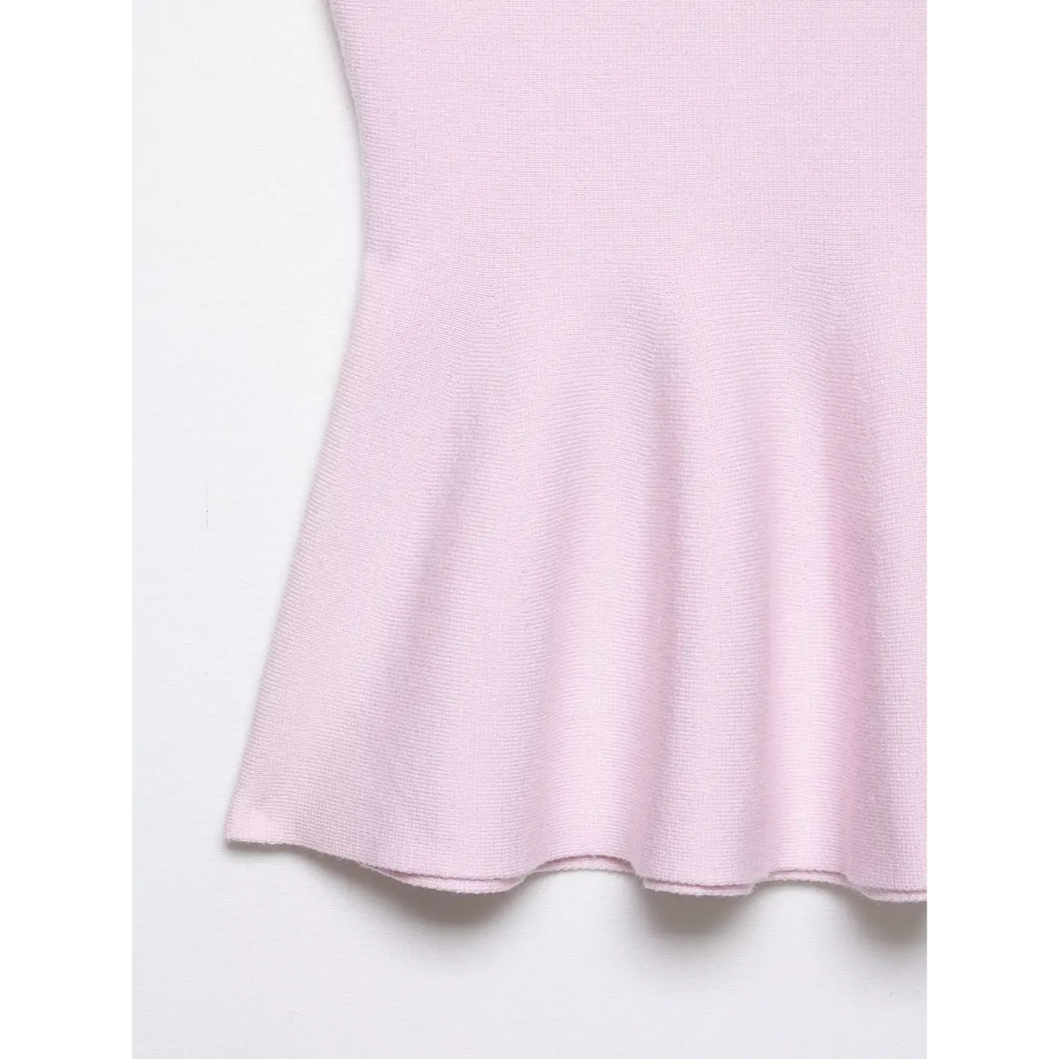 Close-up of flared peplum hem and fabric texture