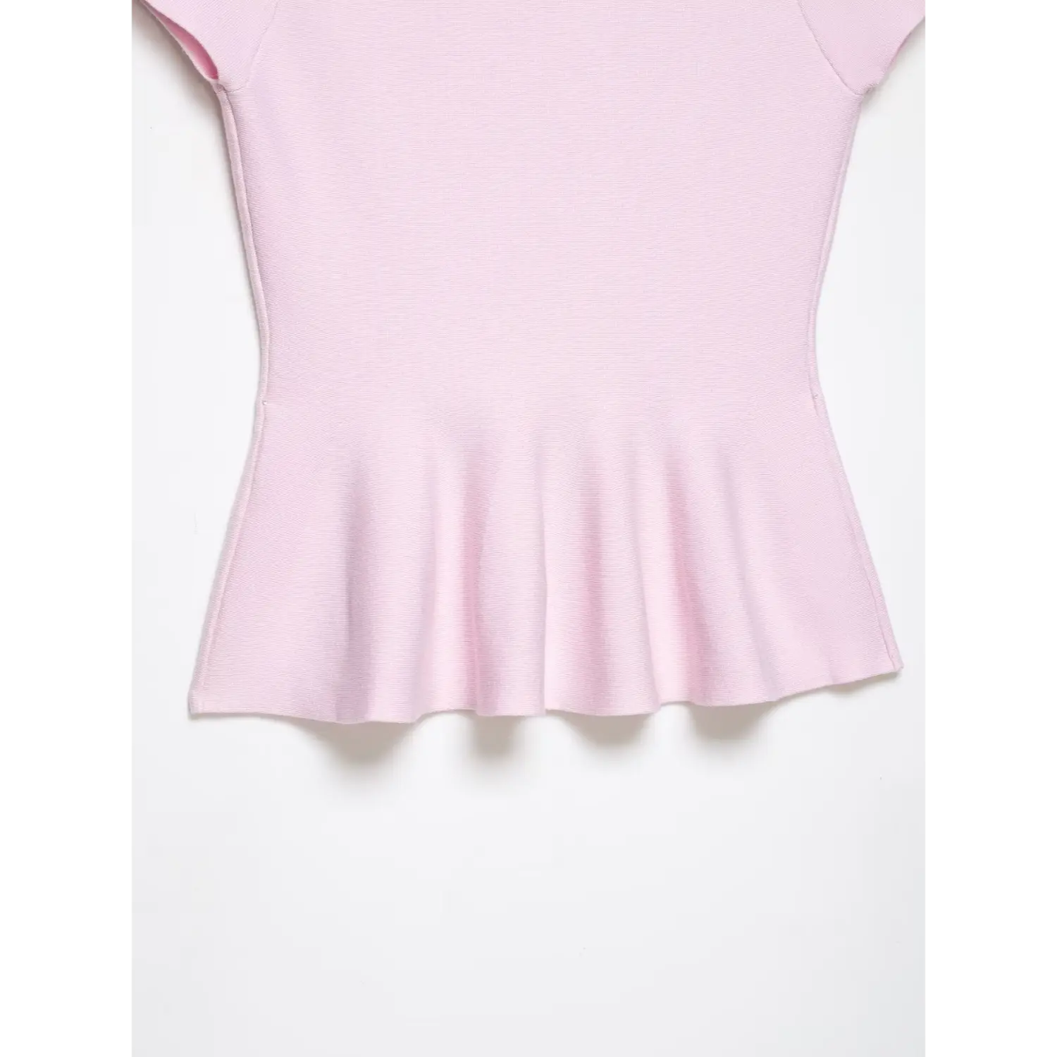 Macro shot of ruffled peplum hem fabric and gathering detail