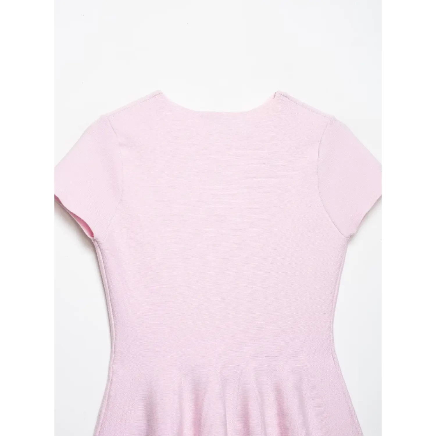 Full back view on white background pastel pink rib knit peplum top