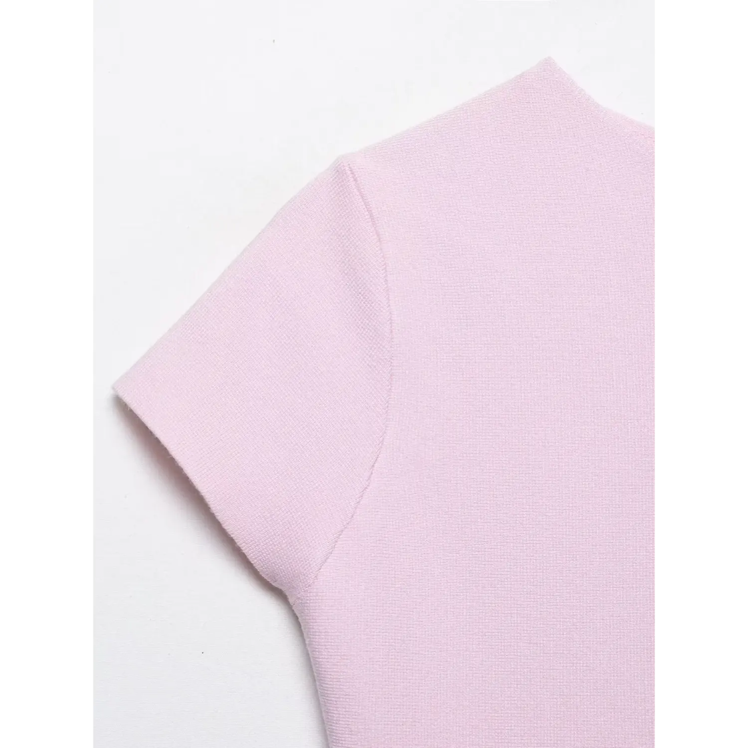 Close-up stitching detail of short sleeve cuff on rib knit peplum top