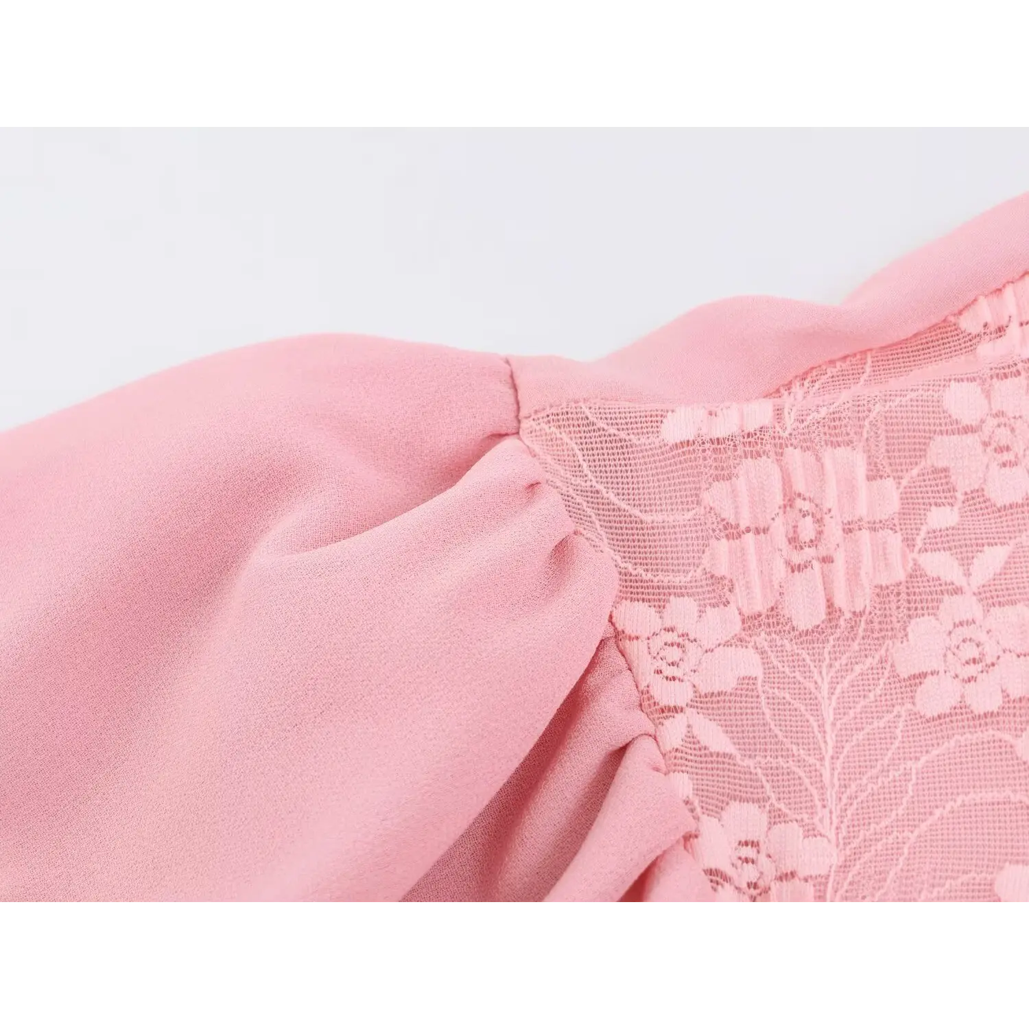 Macro shot semi-sheer floral lace on shoulder yoke, woven flower embroidery texture