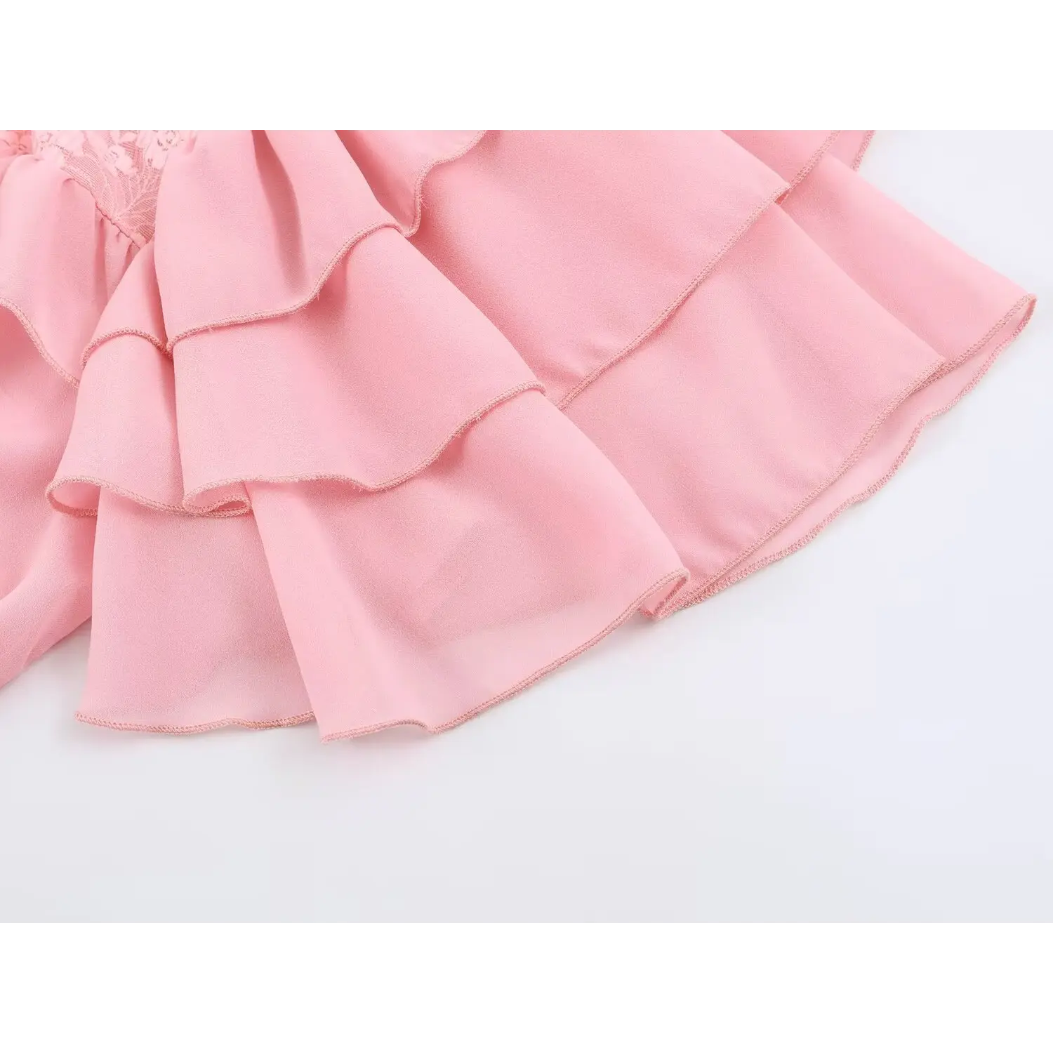 Closeup two-tier ruffle flutter sleeve edge, flowy chiffon layered trim
