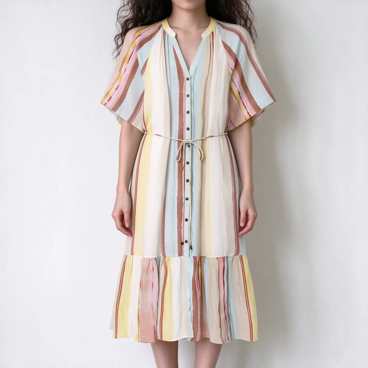 Model in pastel vertical stripe midi dress, short flutter sleeves, front button placket, self tie waist belt, tiered hem