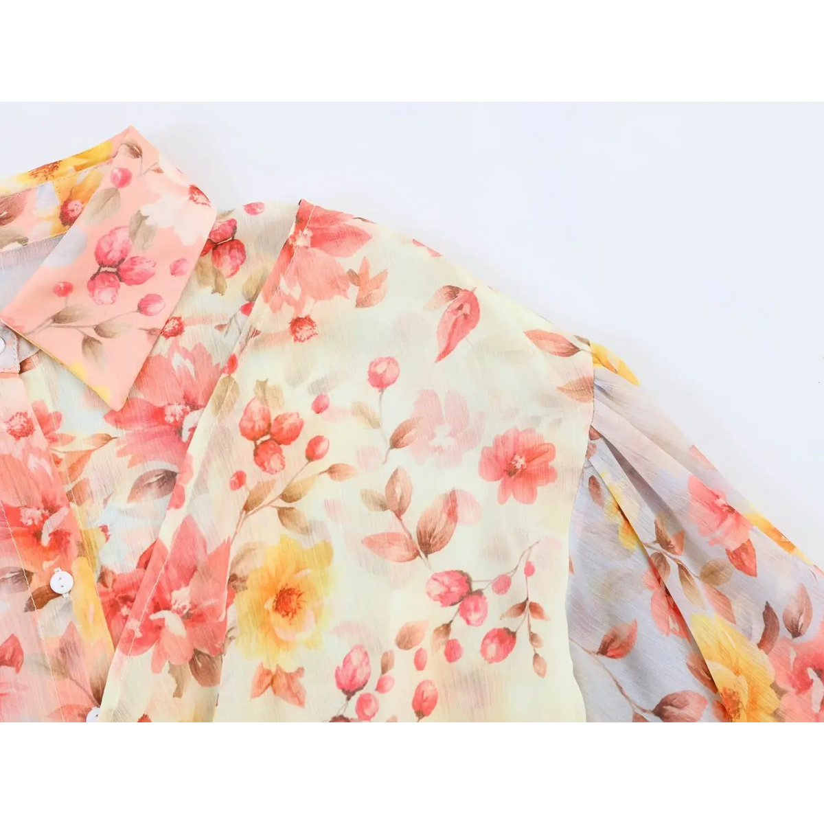 Close‑up of mixed‑print crinkle fabric on bodice of floral maxi dress