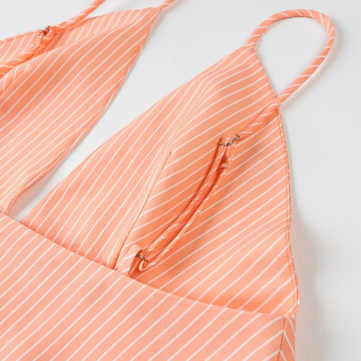 Adjustable slider spaghetti strap close-up peach striped deep v mini dress