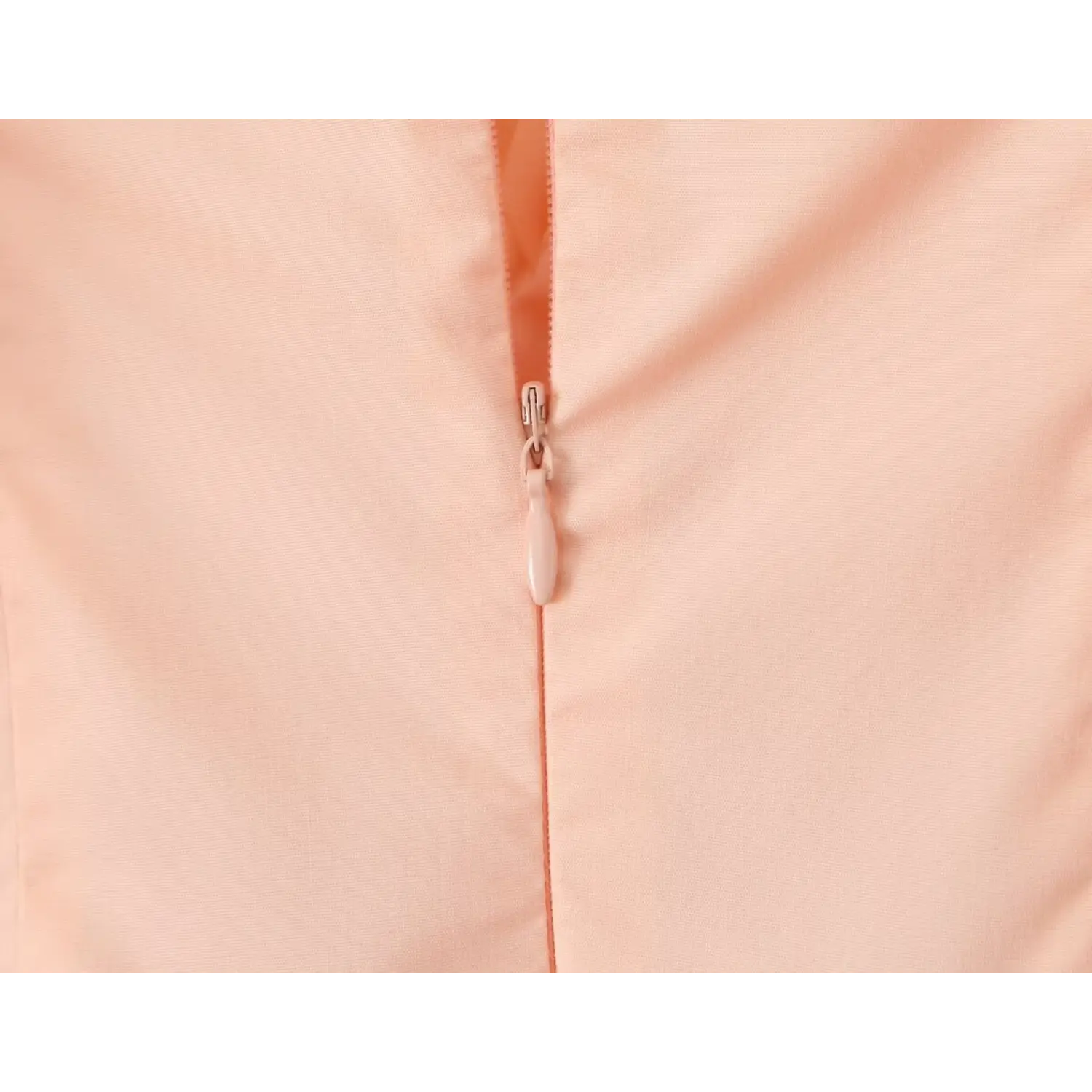 Close‑up of peach dress invisible back zipper, matching peach zipper pull detail