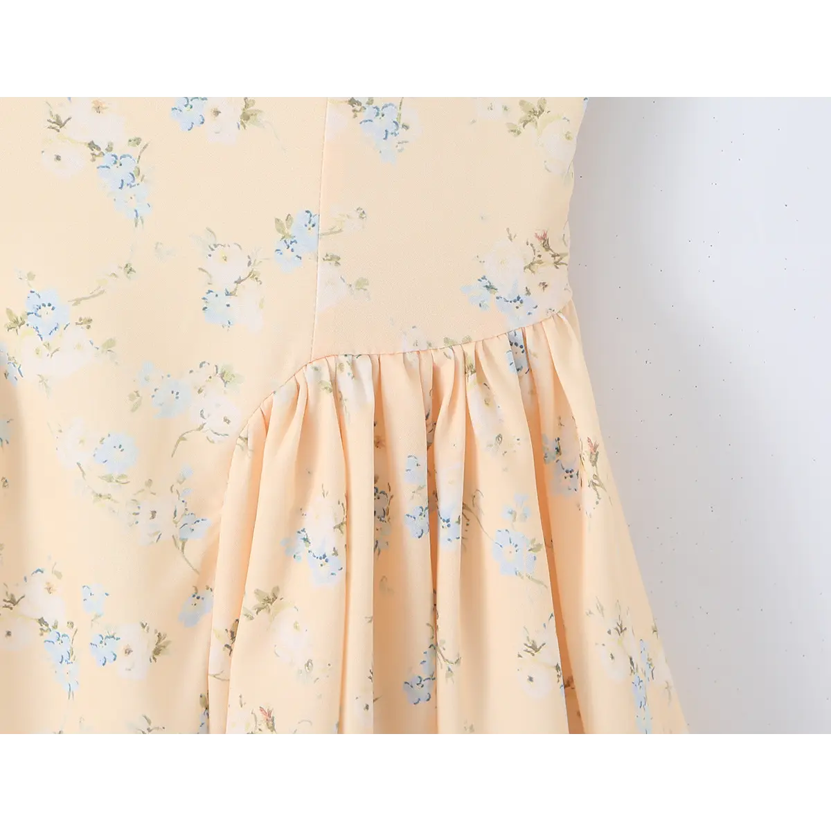Close-up of the gathered waist seam where the corset bodice meets the skirt.