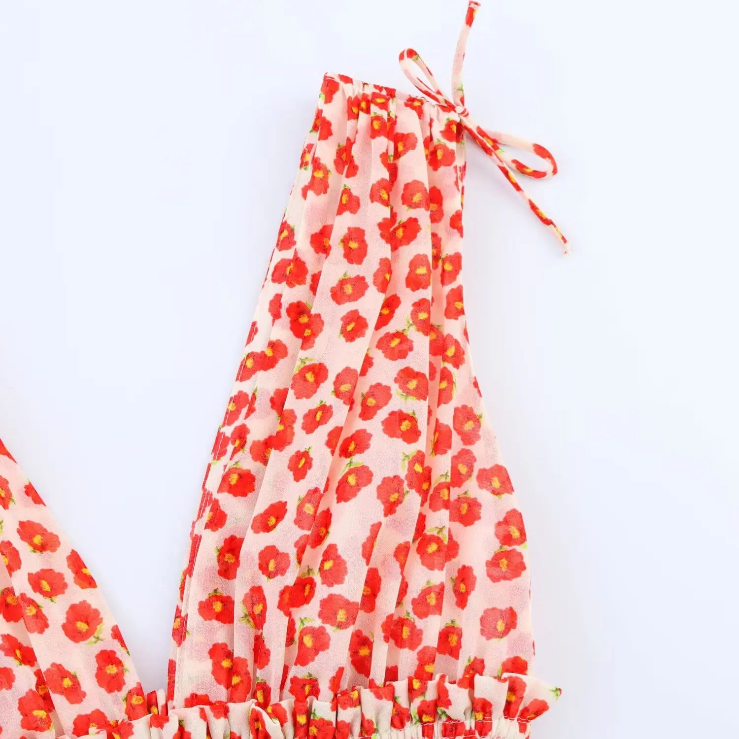 Close-up of the adjustable tie straps at the shoulder of the peach floral dress