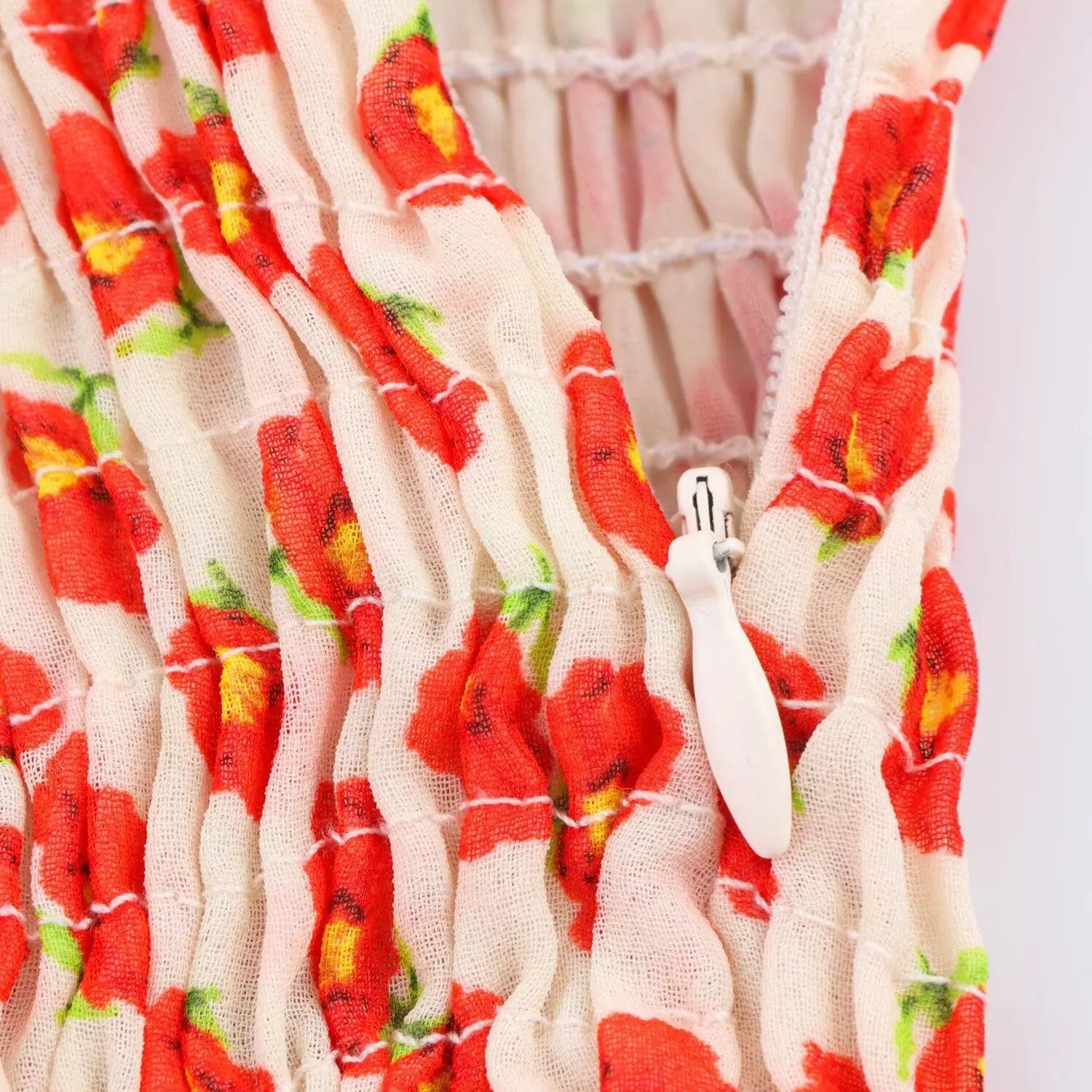Close-up of the smocked elastic waist and side zipper on the floral chiffon dress
