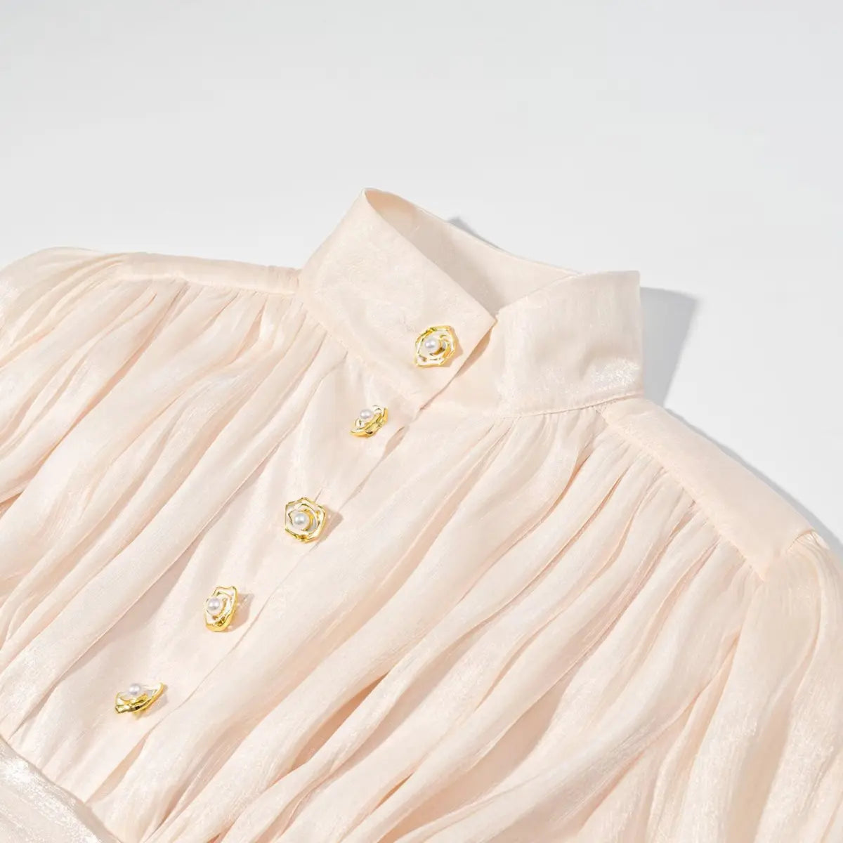 Collar and placket detail of peach iridescent dress, showing the stand-up collar and gold rose buttons