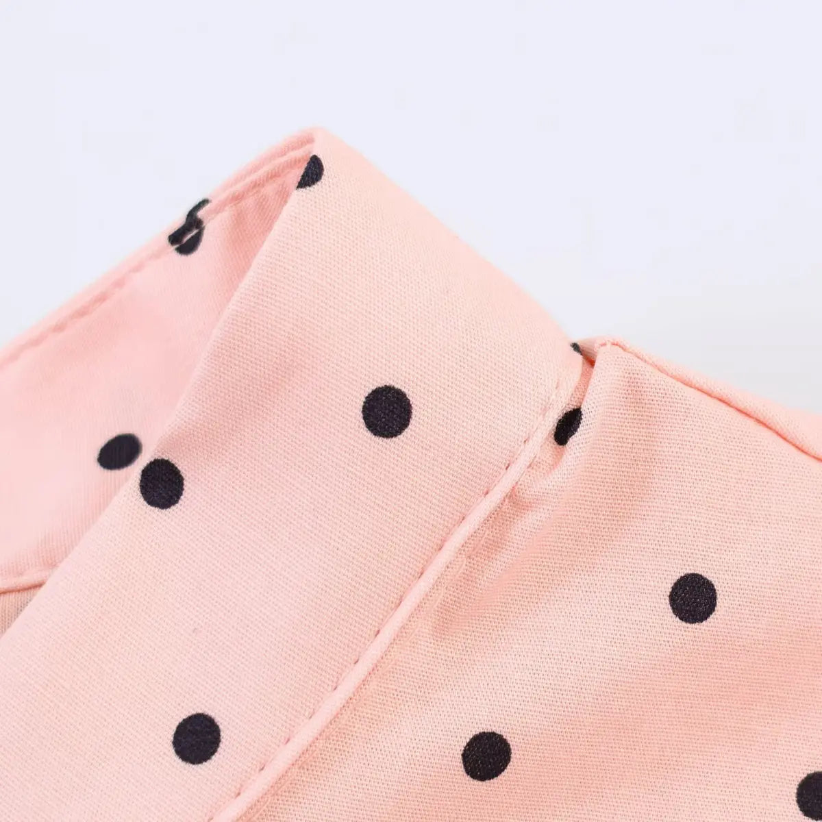  Close-up of the mandarin collar on the peach polka dot top, showing the clean stitching and polka dot pattern
