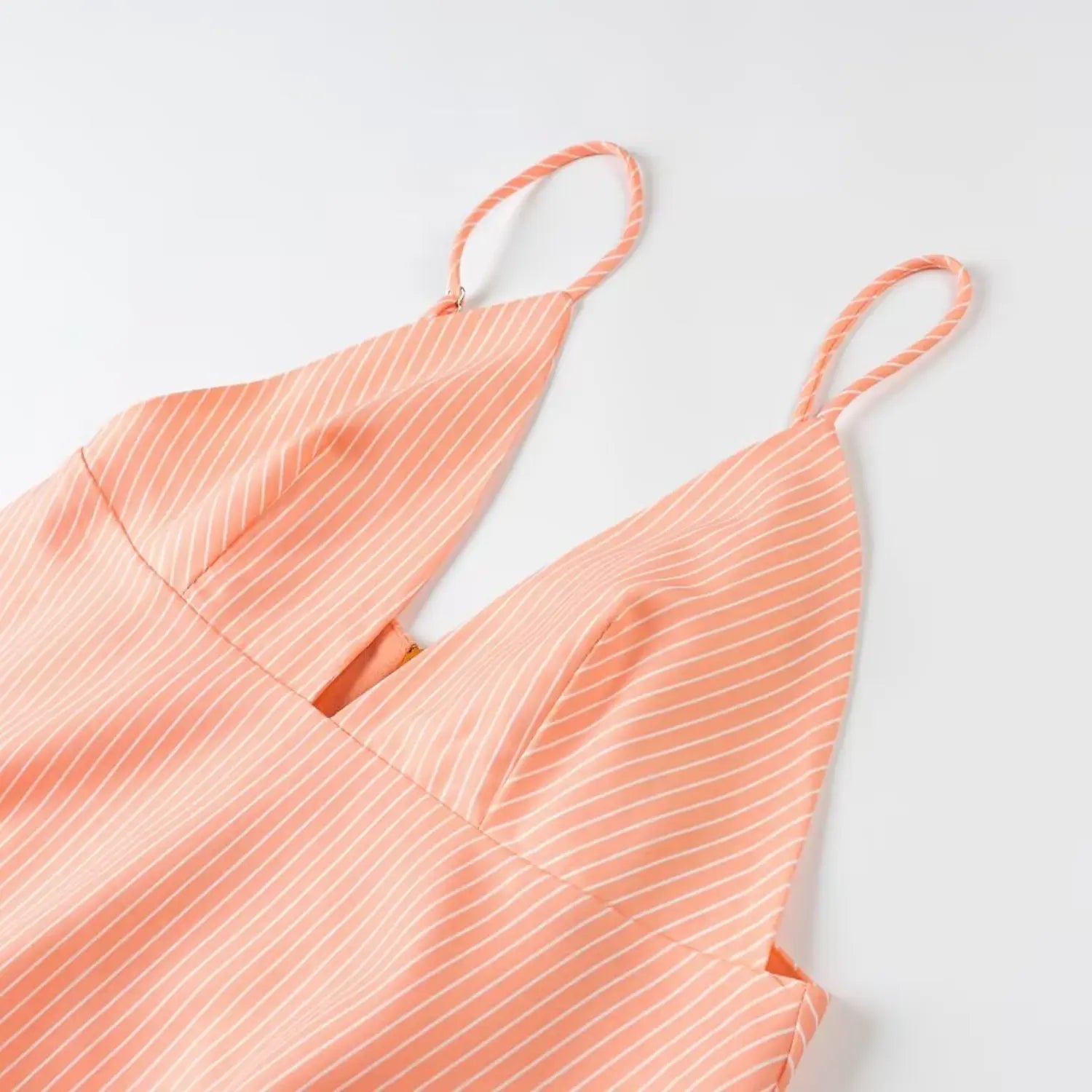 Close-up front deep v neckline peach thin stripe adjustable spaghetti strap dress