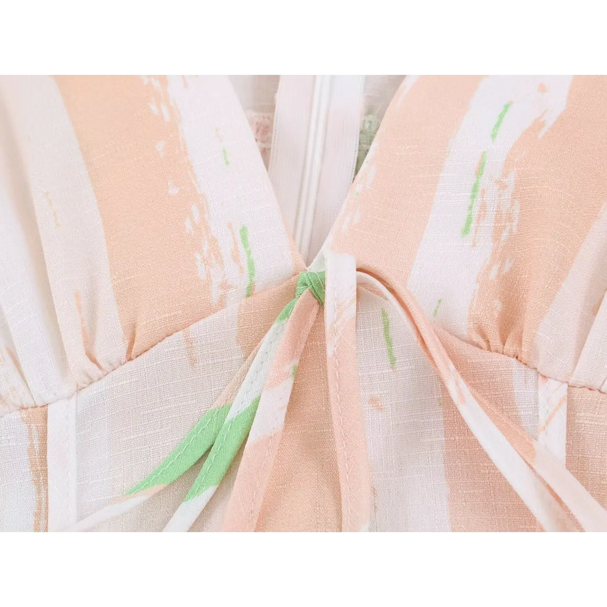Close‑up of front tie detail at bust for peach green stripe maxi dress