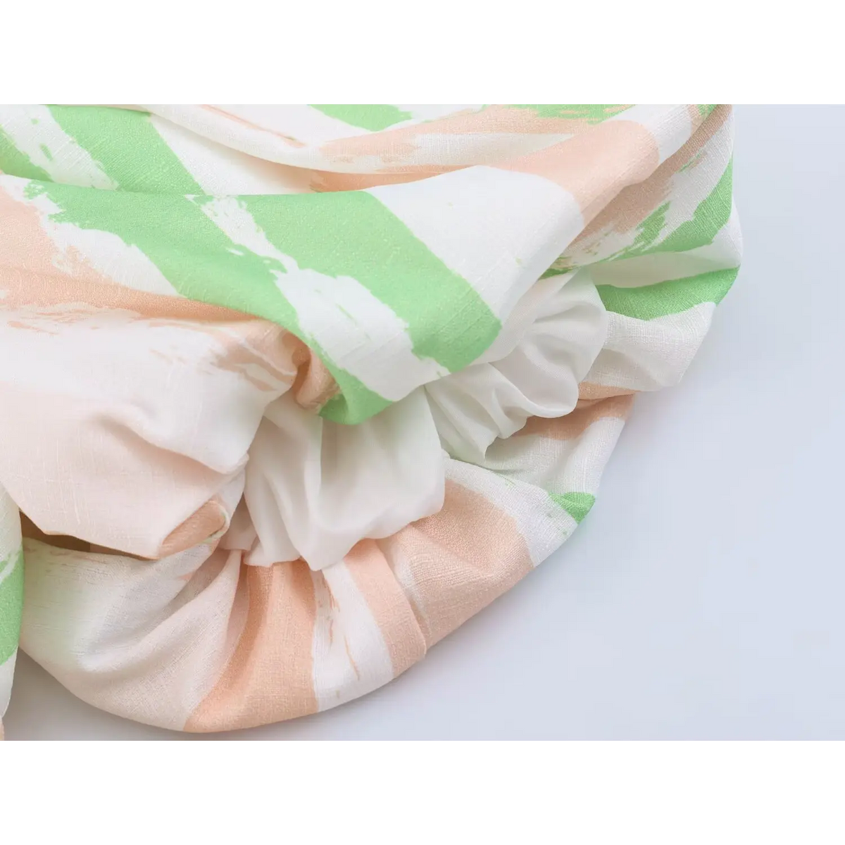 Folded detail view of puff sleeve ruffle for peach green stripe maxi dress