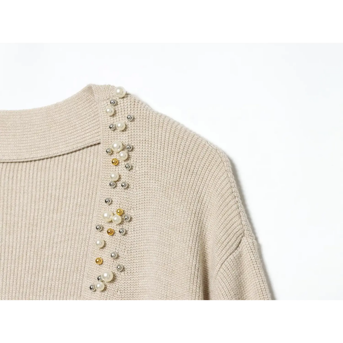 Close-up of shoulder line with pearl, gold and silver bead embellishment