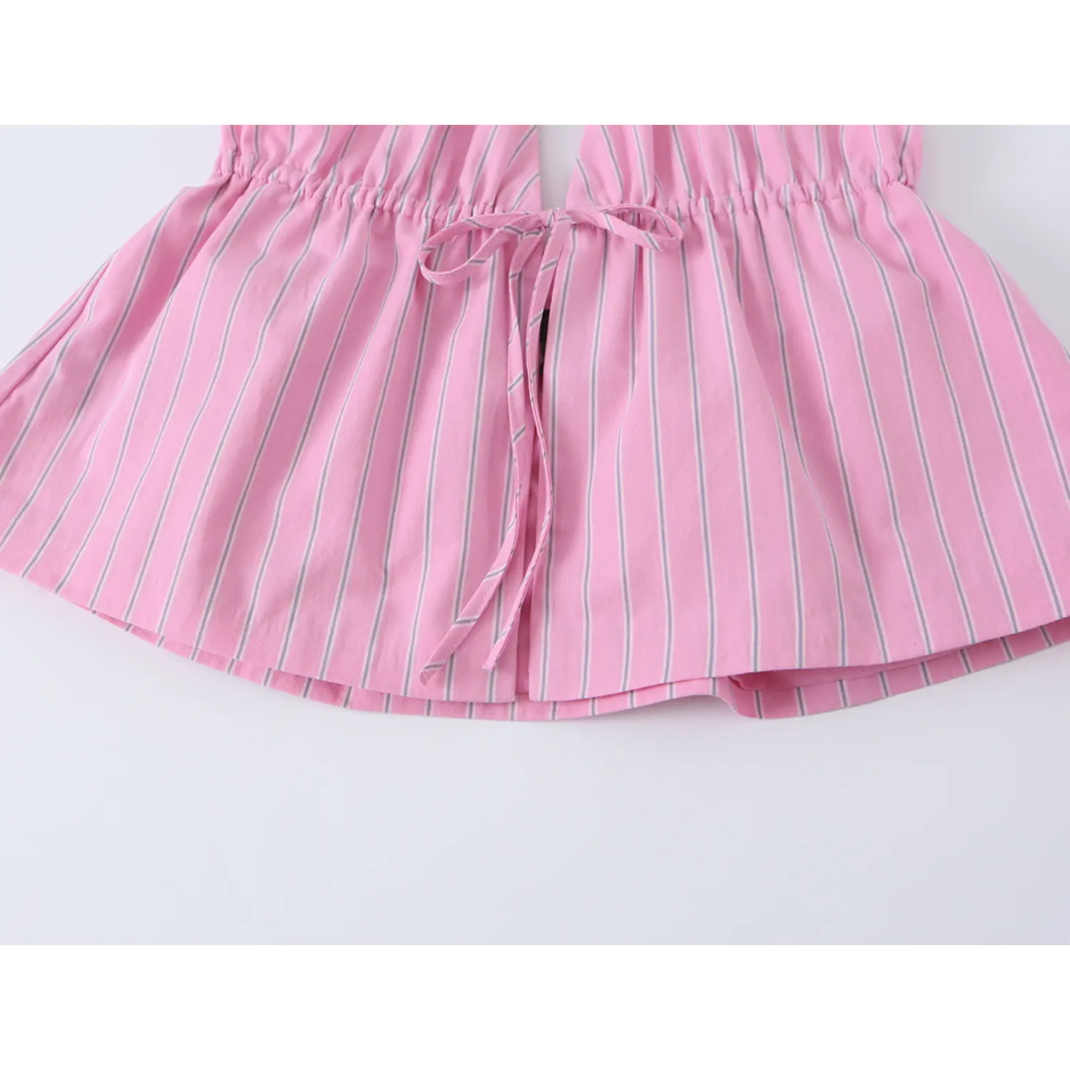 Close-up of double layer fabric hem, neat folded edge workmanship on vertical stripe material