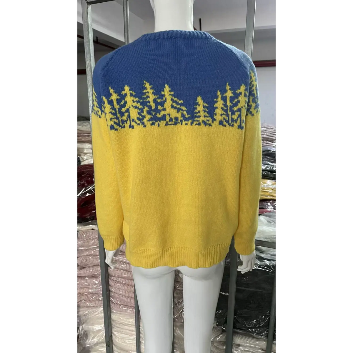 Back view of pine tree colorblock yoke knit sweater on mannequin