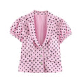 Full front flat lay cropped blazer, pink base black polka dot print, notched lapel collar, three mother-of-pearl buttons placket, short puff bubble sleeves, two fake flap pockets, tailored peplum waist hem, full pink lining