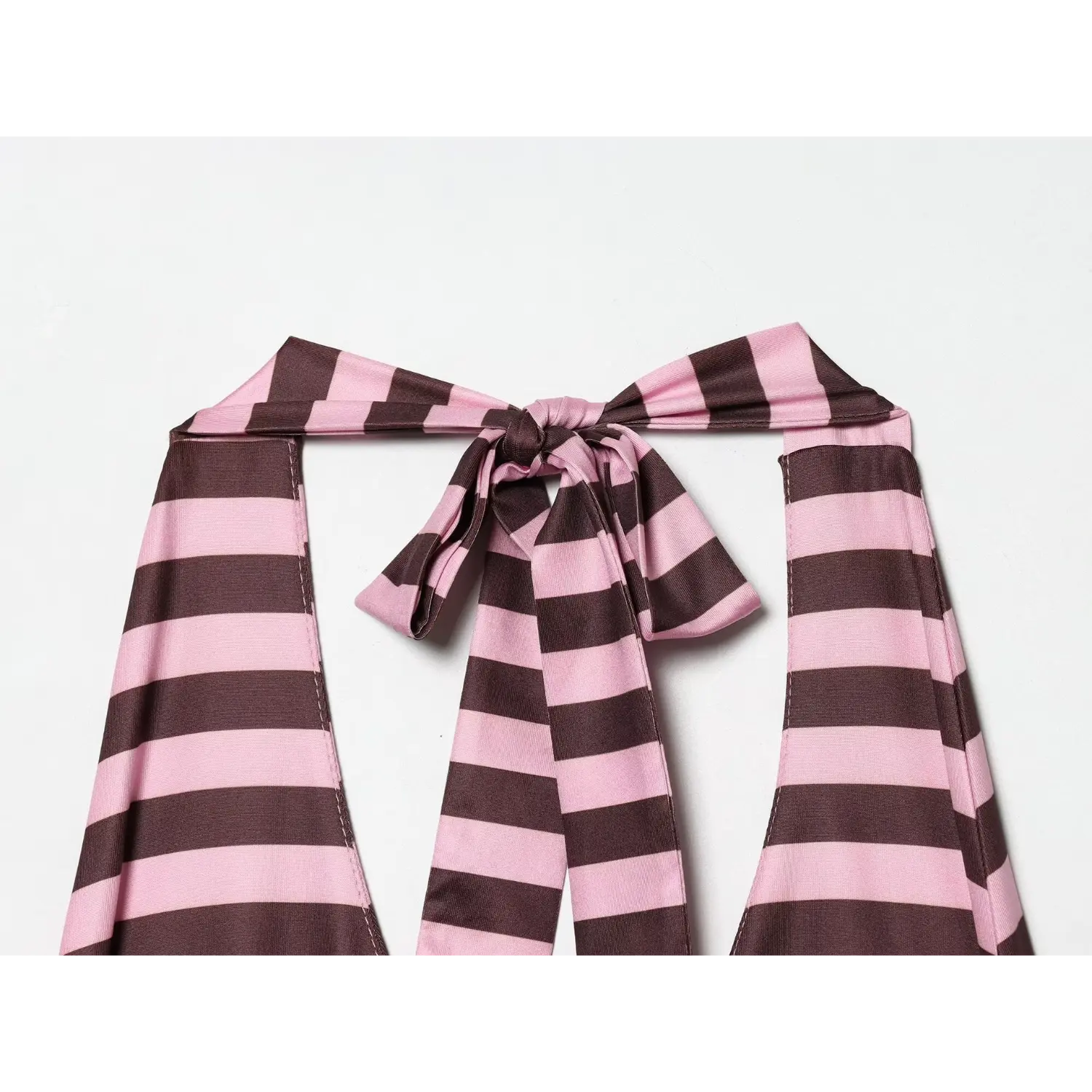 Close-up of self-stripe halter tie bow at nape, long adjustable fabric streamers, folded binding neck edge, matching horizontal stripe print