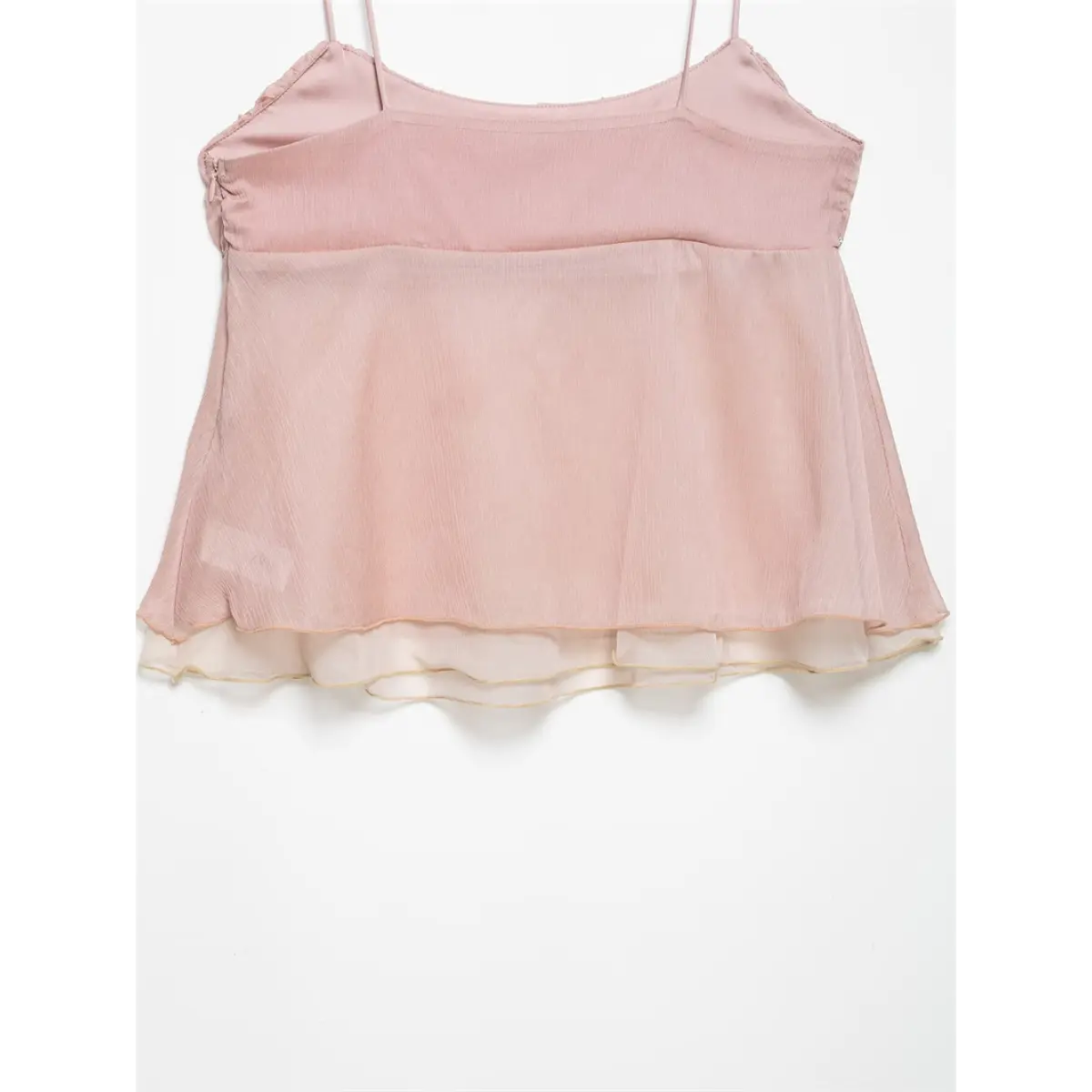 Full back view of a light pink cami top, showing the thin straps, gathered bodice, and flowy double-layered hem.