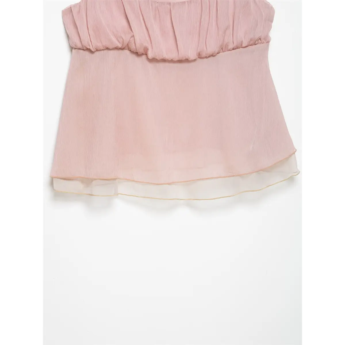 Close-up of the gathered bust area of a light pink cami top, showing the soft crinkled fabric and ruffled construction.