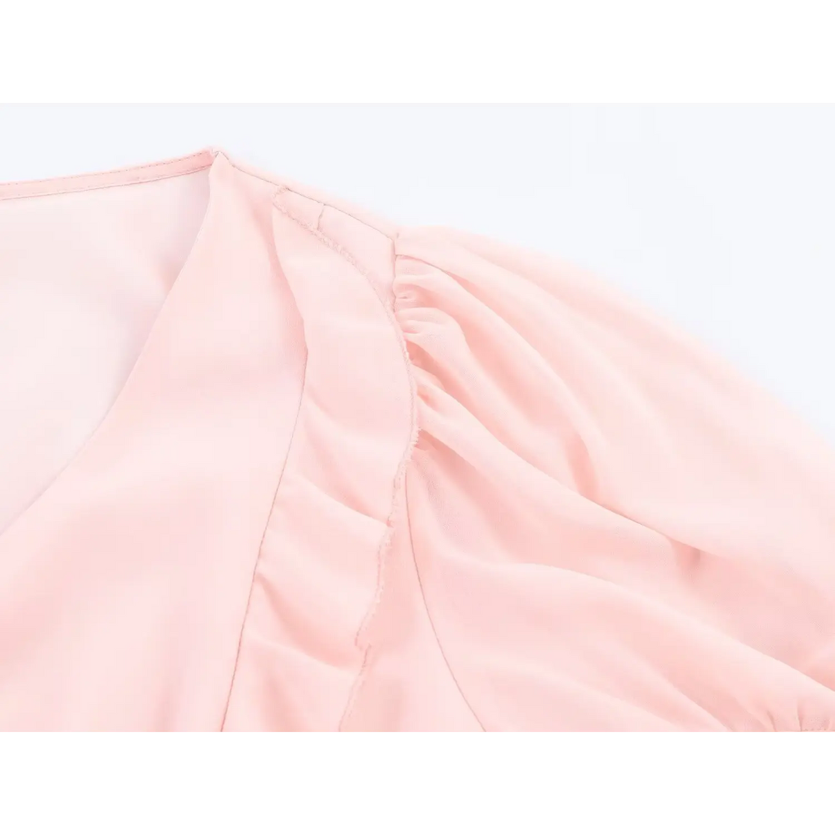 Close up of puff short sleeve and shoulder ruffle detail on pink chiffon maxi dress