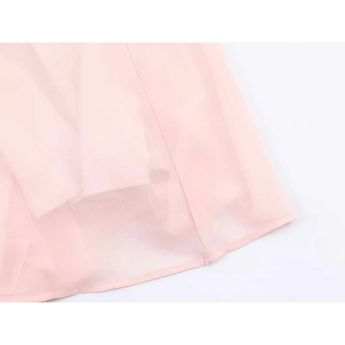 Close up of finished hem, lightweight sheer chiffon fabric of pink long maxi skirt