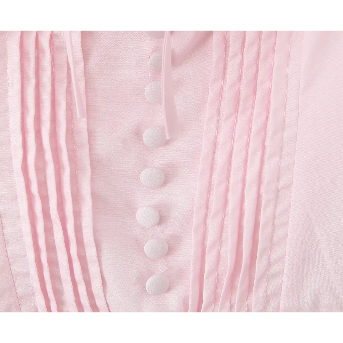 Close-up of vertical button placket and pin-tuck detailing on the corset bodice.