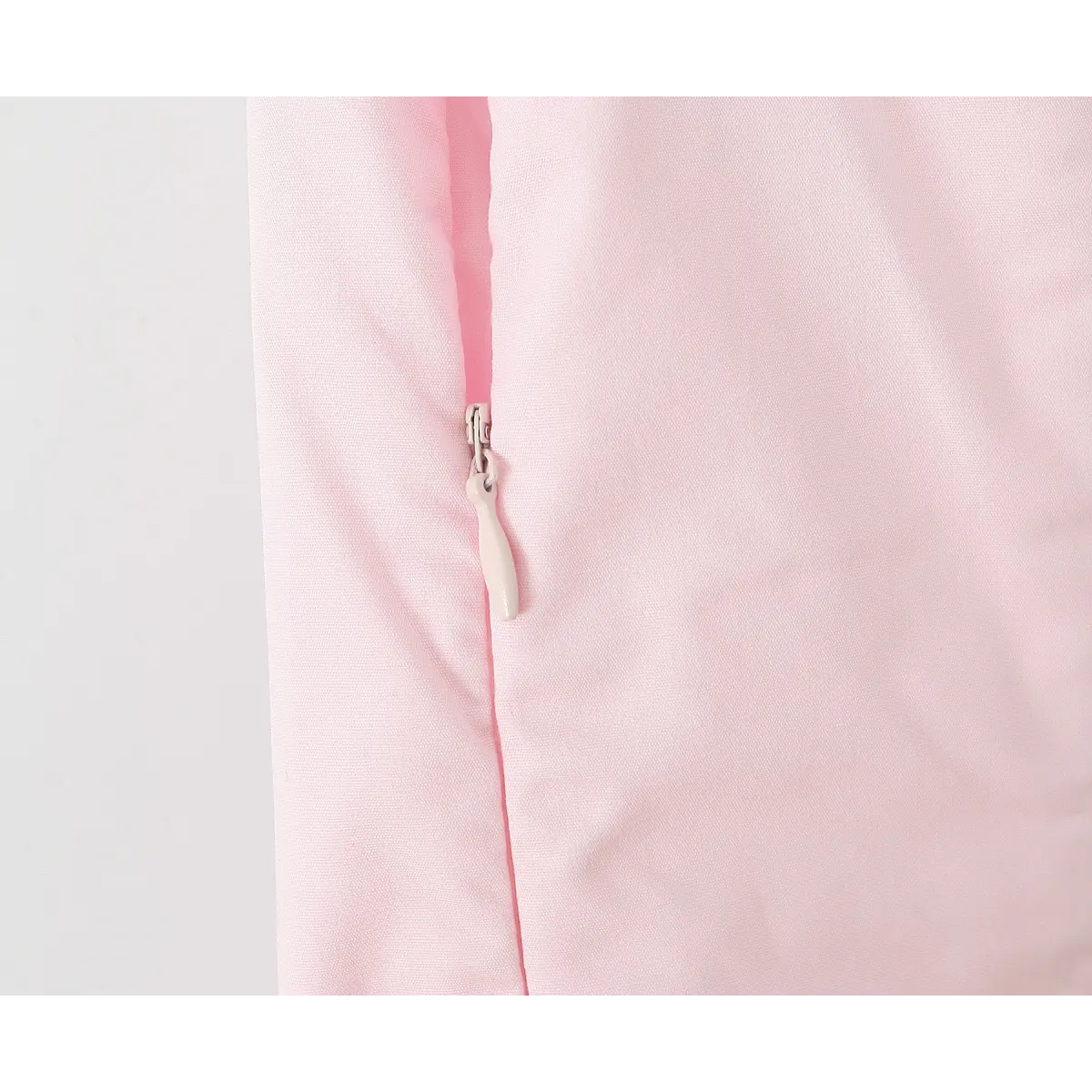 Close-up of invisible side zipper with smooth fabric pull tab.