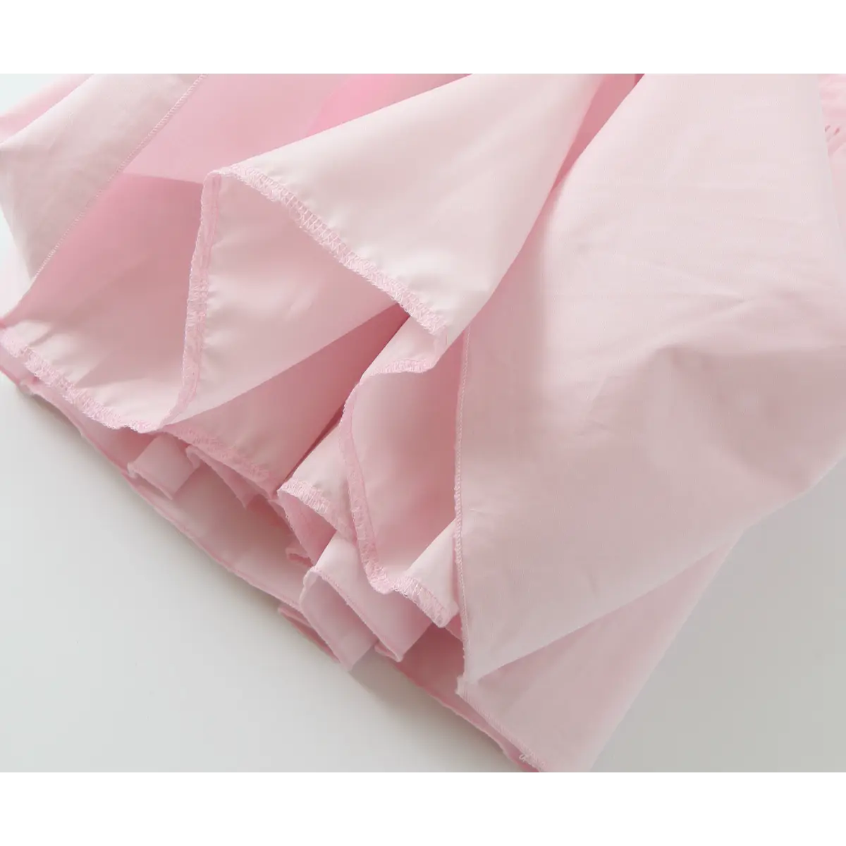 Close-up of flared skirt hem with finished stitching and smooth inner lining.