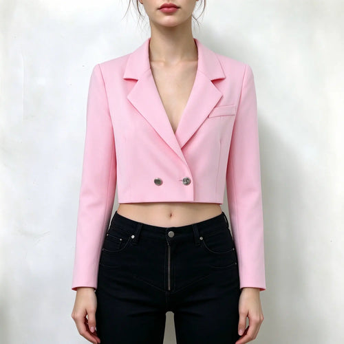 Model wearing pink cropped blazer, notched lapel, double silver button closure, long sleeves, cropped length, paired with black jeans, plain white background
