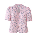Full front view of the pink ditsy floral blouse, featuring the keyhole neckline, puff sleeves, and princess seams