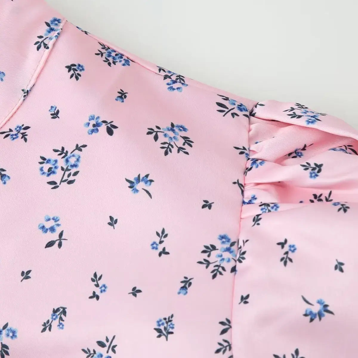 Close-up of the mandarin collar and puff sleeve on the pink ditsy floral blouse
