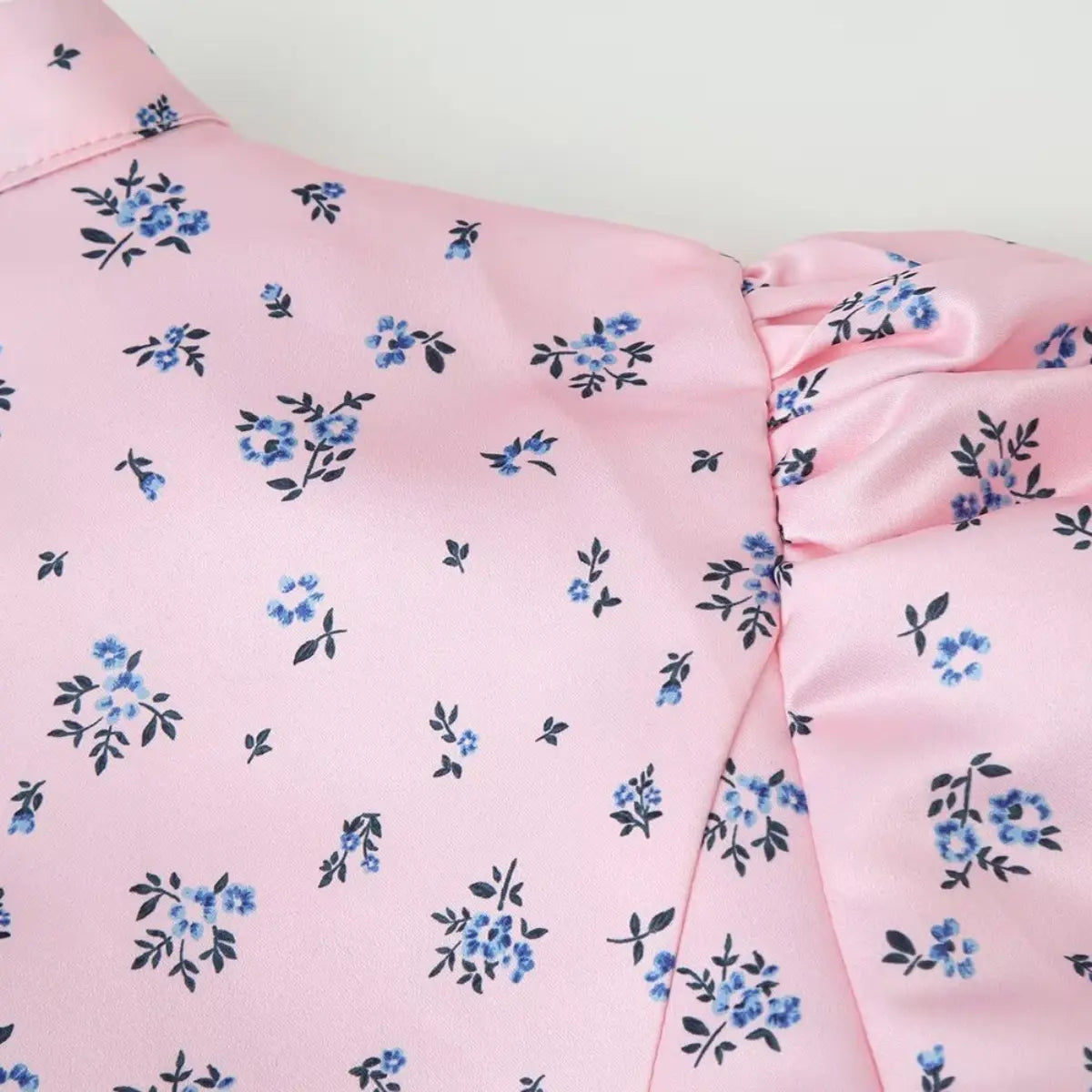 Close-up of the shoulder and gathered puff sleeve on the pink ditsy floral blouse