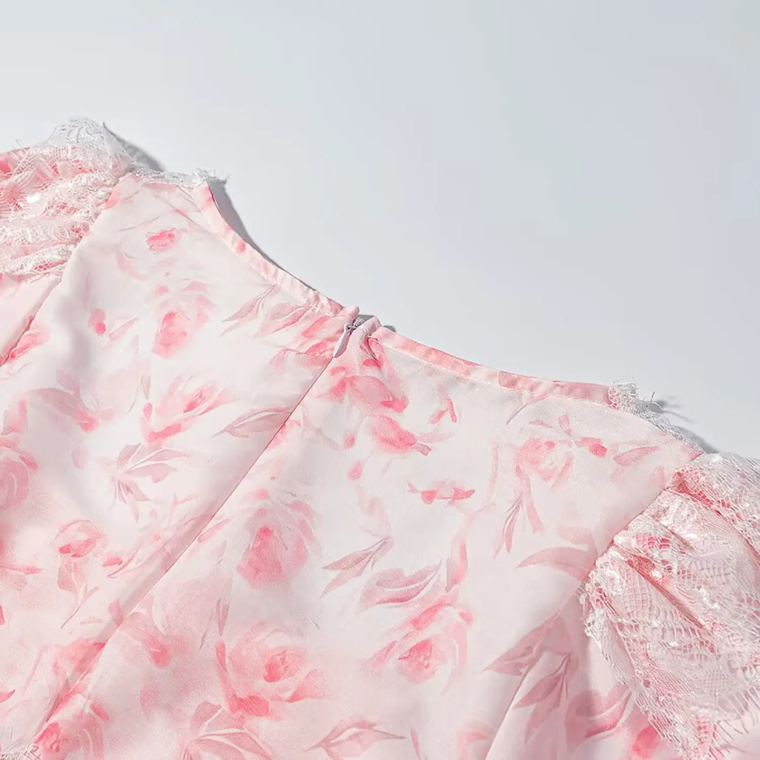 Detail shot back invisible zipper and floral fabric of lace peplum top