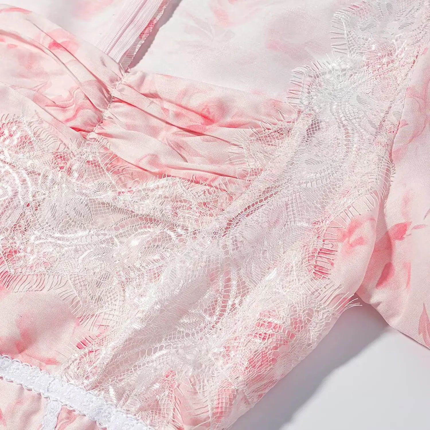 Close up waist lace trim and floral fabric of corset style peplum top