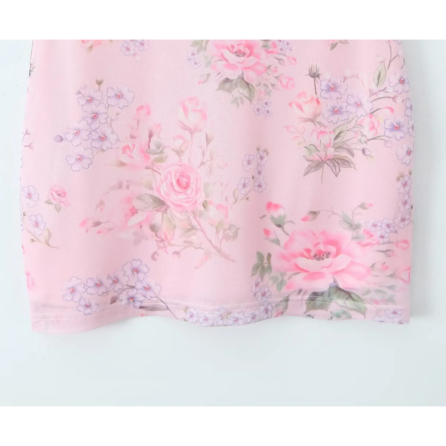 Close‑up skirt section, soft pink mesh fabric with vintage rose and small purple flower print, bodycon mini dress